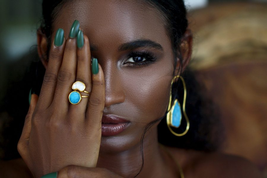 Gold stone ring and earrings on model
